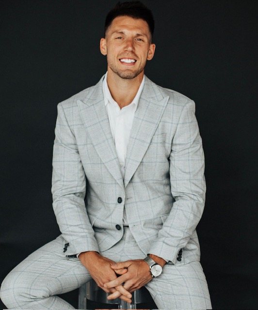 Derek Zaffini wearing a light gray suit