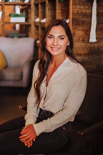 Maria Evans wearing a tan shirt